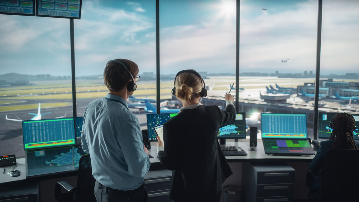 airport control room with view of airplanes on runway